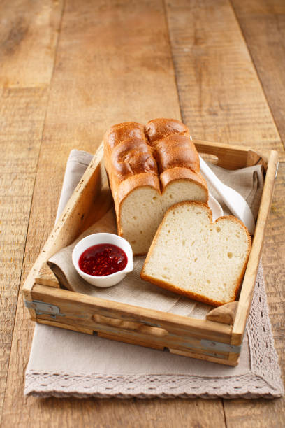 Freshly Baked Brioche Bread with a Slice Cut, Served with Marmalade