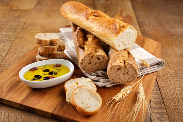 istock French Baguettes on a Cutting Board with Olive Oil 2200852437