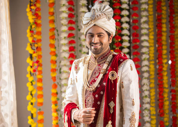 istock Groom in traditional clothing looking at camera during wedding ceremony 2200852592