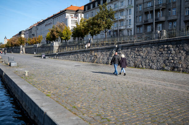 Views walking along the Naplavka-Rasinovo river bank in Prague, Czech Republic.  This river embankment is one of the more attractive venues on the banks of the river Vltave in downtown Prague.  The embankment is lively with a range of activities from farmer's markets to sports and cultural activities.