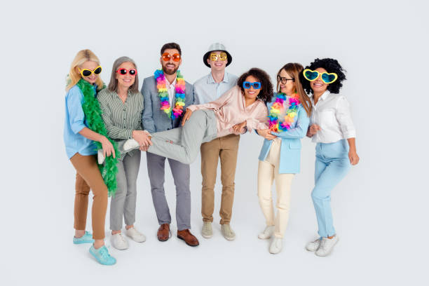 istock Professional group of diverse colleagues celebrating teamwork in office attire against a grey background 2200853469