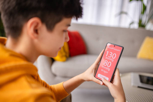 Young woman enjoys relaxing at home while checking her smartphone with a cheerful expression and a cool demeanor