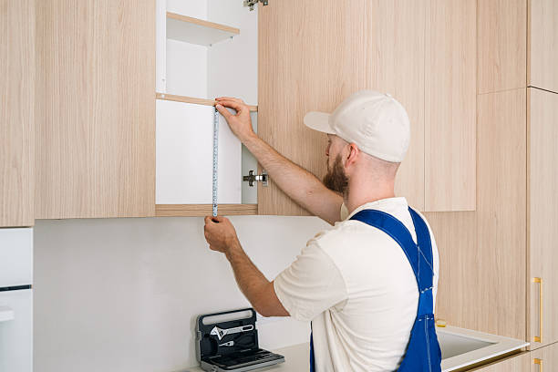 istock Handyman measuring for cabinet installation during kitchen renovation 2200856404