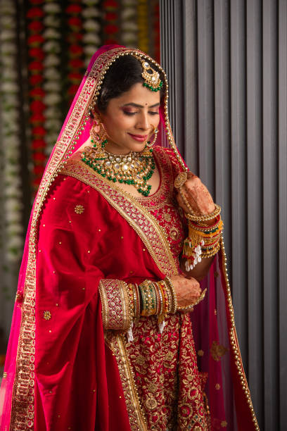 istock Bride with dupatta on head looking down in wedding ceremony 2200856908