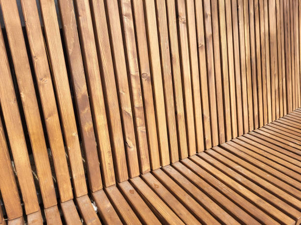 istock Brown bench with a high back made of narrow slats 2200857404