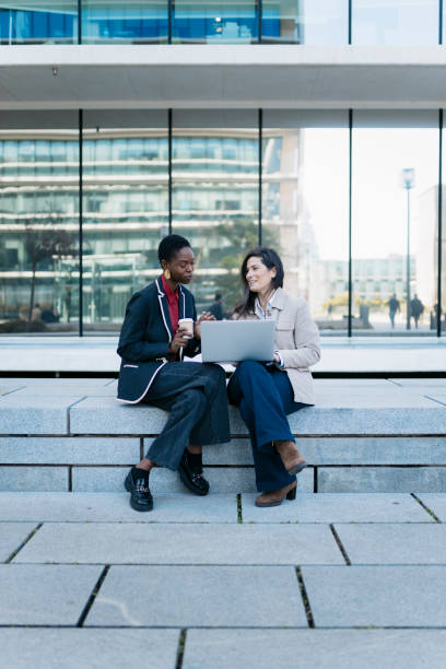 istock Two businesswomen collaborating outdoors with laptop 2200859304