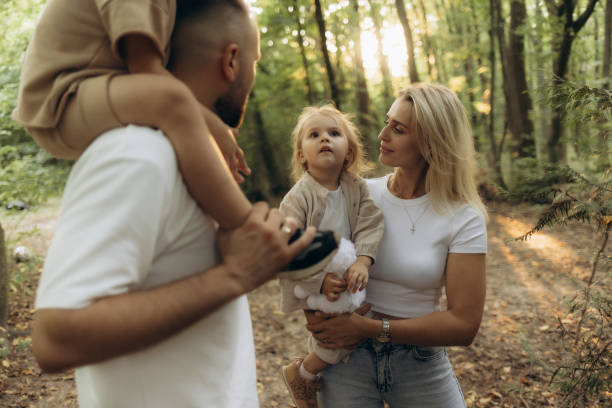 istock Happy Family Spending Quality Time in the Forest During a Sunny Day 2200859982