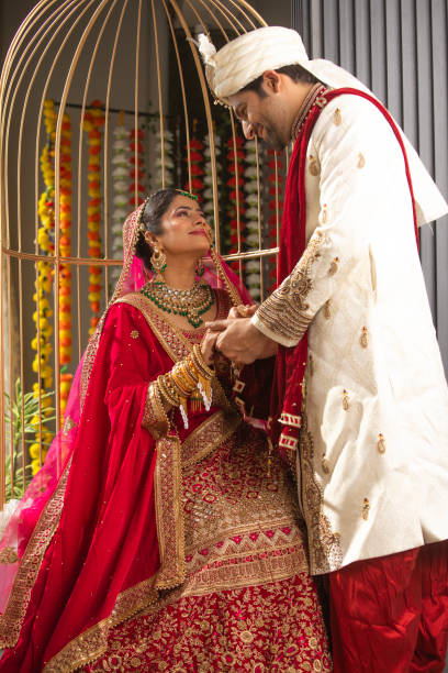 istock Loving groom looking at bride in wedding ceremony 2200860567