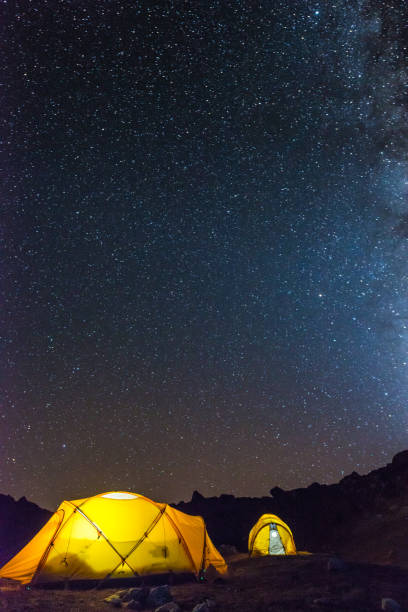 istock Stars shining over illuminated dome tents camping Himalayas basecamp Nepal 2200861488