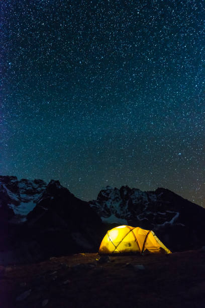 istock Stars shining at night warmly illuminated tent Himalayan mountains Nepal 2200861627