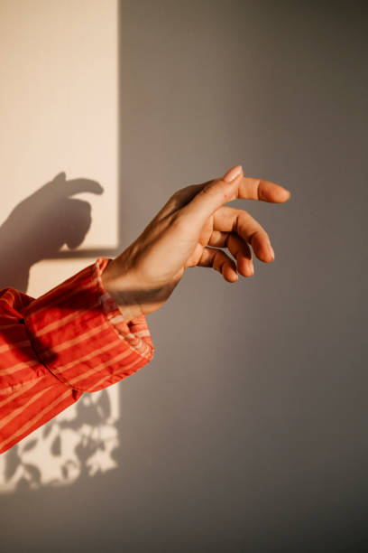 istock Sun and shadow hand play in early morning 2200862424