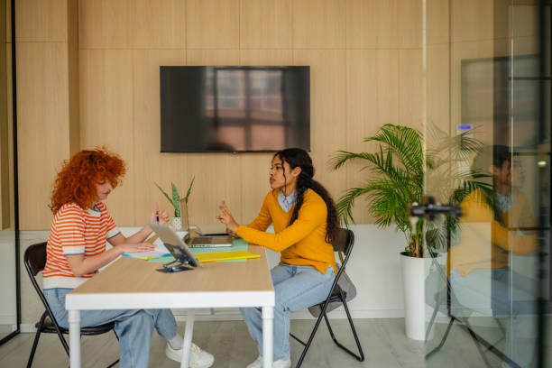 istock Collaboration and discussion between two businesswomen in a modern office setting fostering teamwork and innovation 2200863425