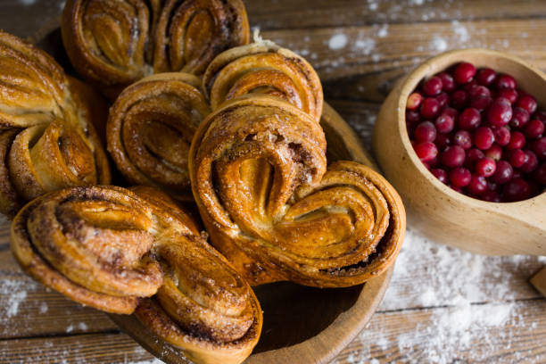 istock Cinnamon rolls on a plate and a pot of cranberry tea 2200863854