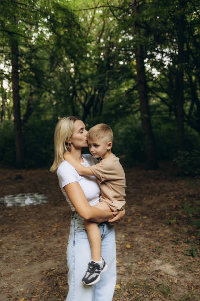 A mother and son walking in the park
