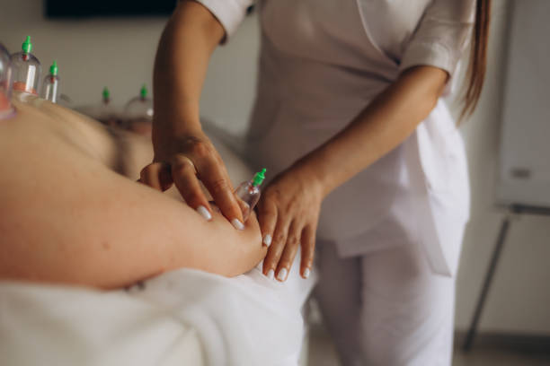 Realistic photo of a man undergoing cupping therapy with a white background. Traditional holistic healthcare concept. Ideal for illustrating alternative medicine practices.