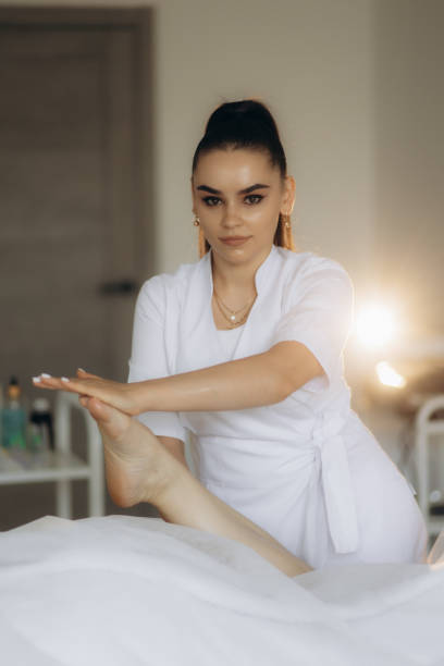 istock A therapist is performing a relaxing foot massage on a client who is lying down, set against a backdrop of soft, warm ambient lighting that suggests an evening atmosphere designed for relaxation 2200865409