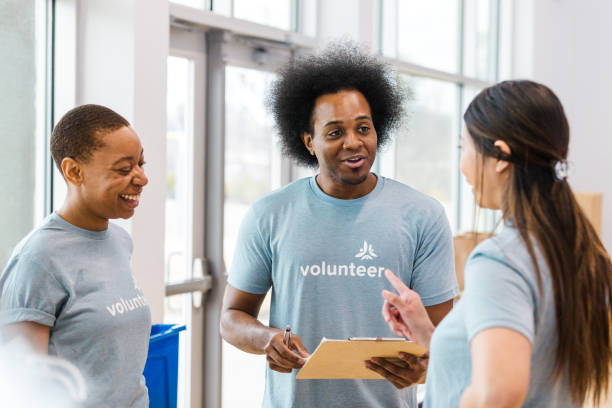 istock Three Volunteers Discussing Tasks at a Community Center 2200866865
