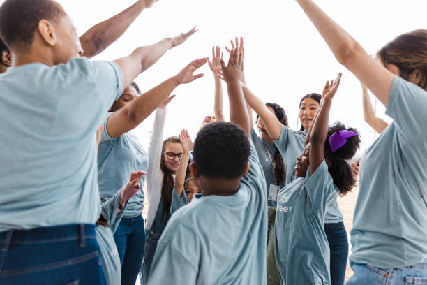 istock Diverse Group of Volunteers High-Five, Celebrating Teamwork and Community 2200866881