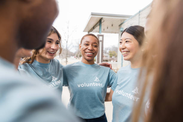 istock Happy Diverse Group of Volunteers Embracing Teamwork 2200866899