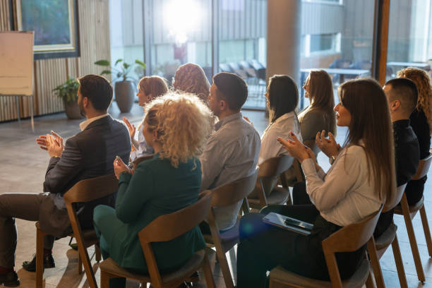 istock Businesspeople applauding during conference 2200867533