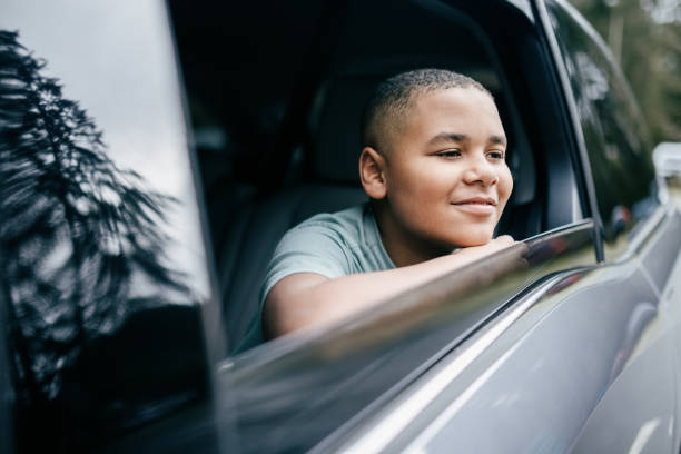 istock Cheerful Elementary Aged Boy Riding In Family Vehicle 2200868494