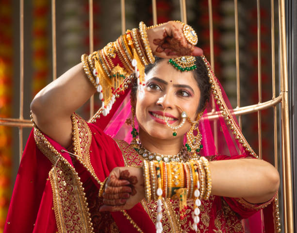 istock Smiling bride in wedding dress showing her bangles 2200868634