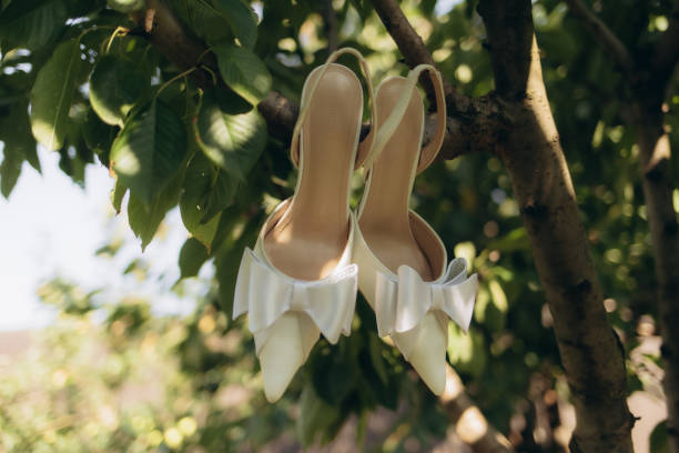 Wedding shoes hanging on a tree close up