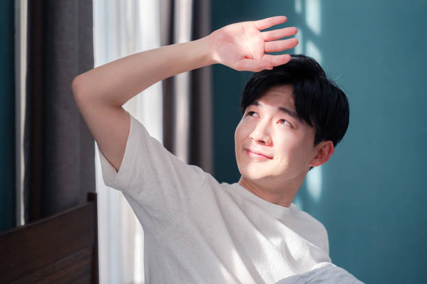 A young man waking up fresh in the morning sun.