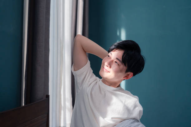 istock A young man waking up fresh in the morning sun. 2200869517