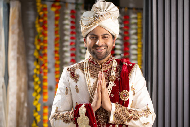 istock Happy groom greeting in prayer pose at wedding ceremony 2200870595