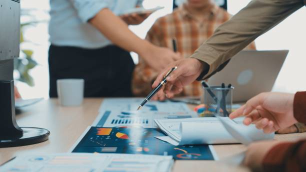 istock Collaborative Business Meeting with Focus on Data Analysis and Strategy Development in Modern Office Environment SACTR 2200870672