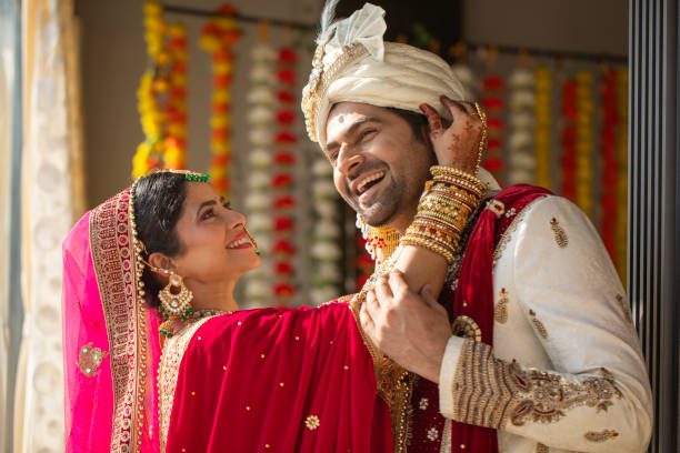 istock Bride adjusting groom's turban at wedding ceremony 2200870781