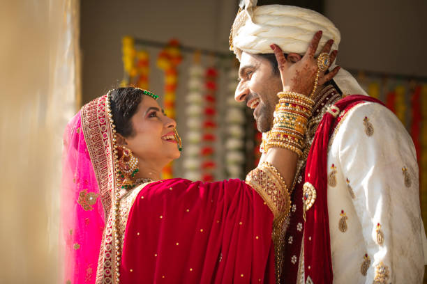 istock Bride adjusting groom's turban at wedding ceremony 2200870885
