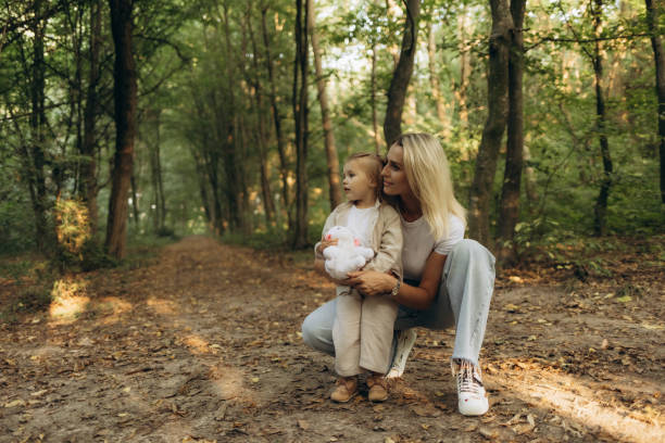 istock Mother and Daughter Enjoying Time Together in Beautiful Forest Setting 2200873175