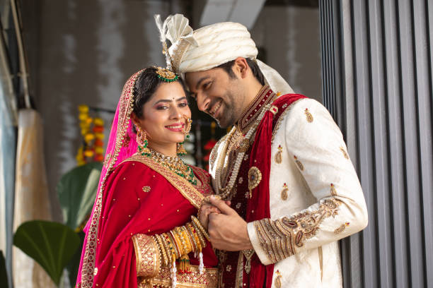 istock Loving groom looking at bride in wedding ceremony 2200873554