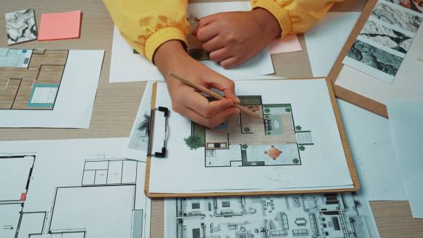 istock Detailed Architectural Planning with Drawings, Sketches and Colorful Notes on a Work Surface by a Designer in a Creative Workspace SACTR 2200874398