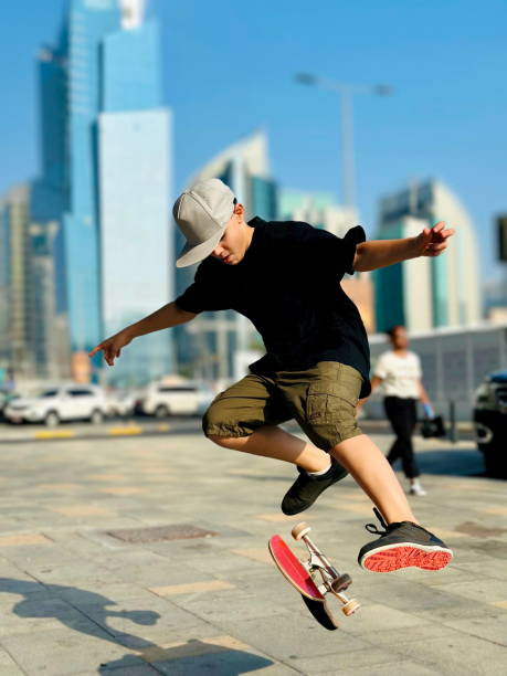 istock A Young Skateboarder Performing a Trick in an Urban Cityscape 2200874664