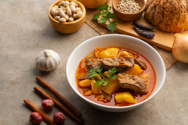 istock Massaman Curry with beef.Cooked beef meat and potatoes groundnut with massaman curry paste in coconut milk on white bowl. 2200875599