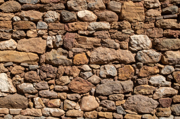 istock Old colorful stone wall closeup in sunny day 2200875872