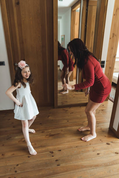 istock mother and daughter dancing at home 2200876814