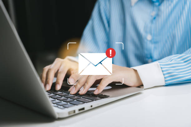 istock Person using laptop to manage email with notification alert 2200879331