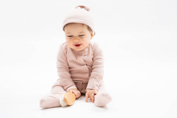 istock Cute Baby Girl Sitting on White Background 2200881099