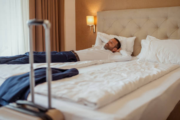 istock Overworked Executive Taking a Nap in a Hotel Room 2200881691