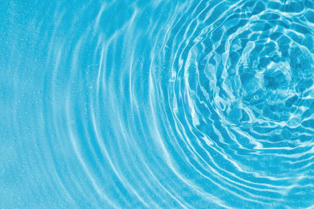 istock drops on water with circles on a blue background 2200884997