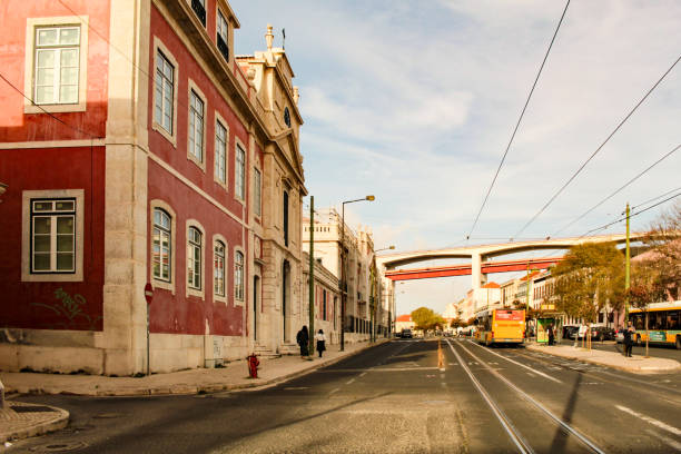 Facades of the Palácio Condes da Ribeira Grande, on Rua Junqueira, and the 25de Abril bridge, in the district of Belem Lisbon, Portugal