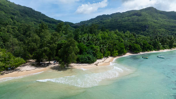 istock Pristine beach with turquoise waters and lush greenery. Seychelles, Mahe. 2200892460