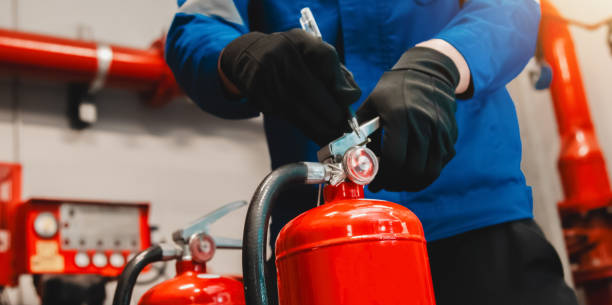 istock Engineer checks fire extinguisher in fire control room to ensure safety. When an emergency occurs 2200892537