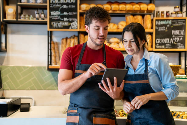 istock Waiter training a new employee at a coffee shop 2200892650
