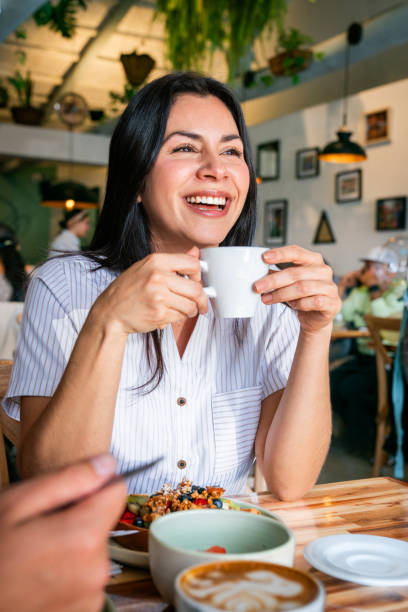 istock Happy woman drinking a cup of coffee 2200892664