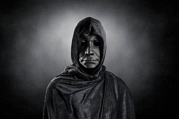 istock Scary figure with hooded cloak over dark misty background with clipping path 2200895514